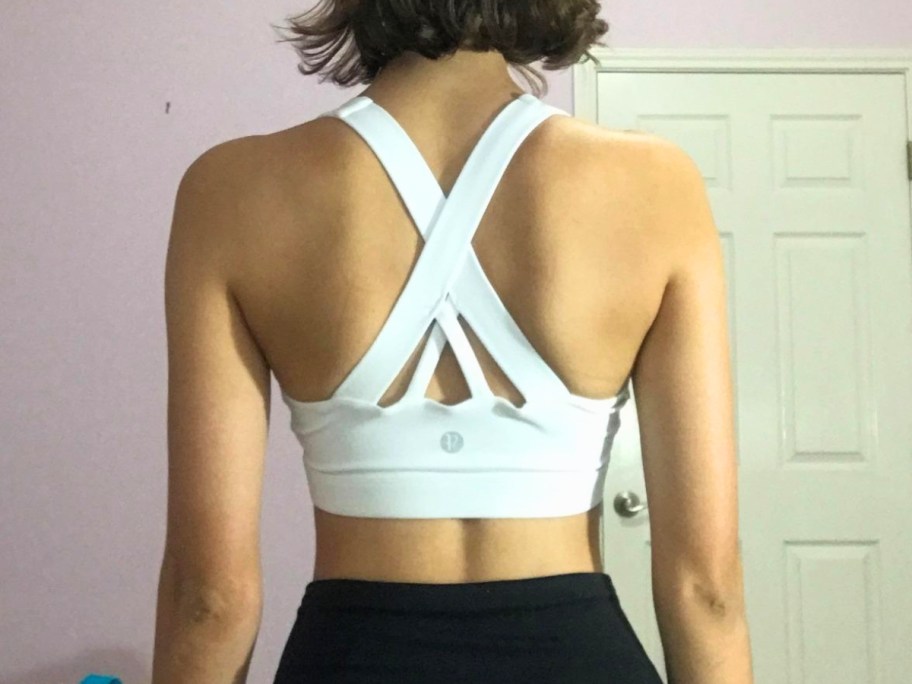woman wearing white running girl sports bra with back showing