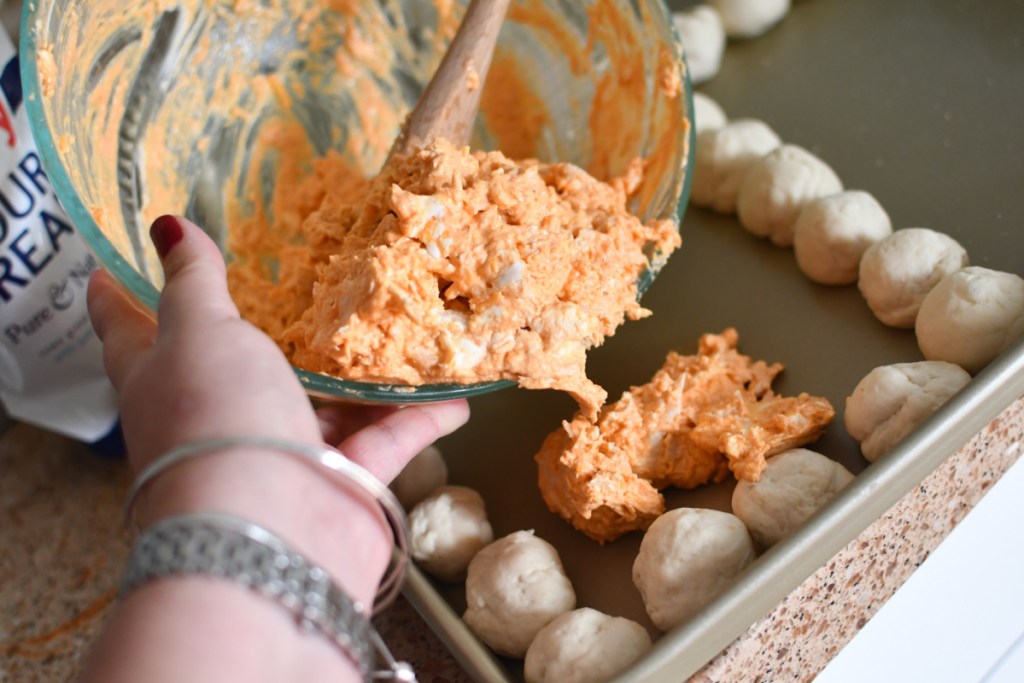 Spreading cheese dip onto a sheet pan to make a quick party appetizer