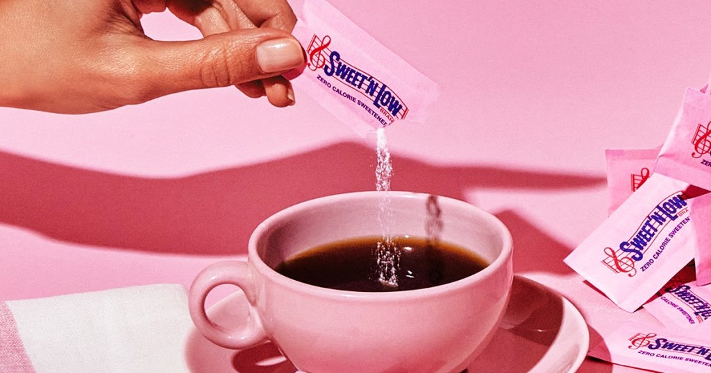 pouring Sweet'N Low into cup of coffee