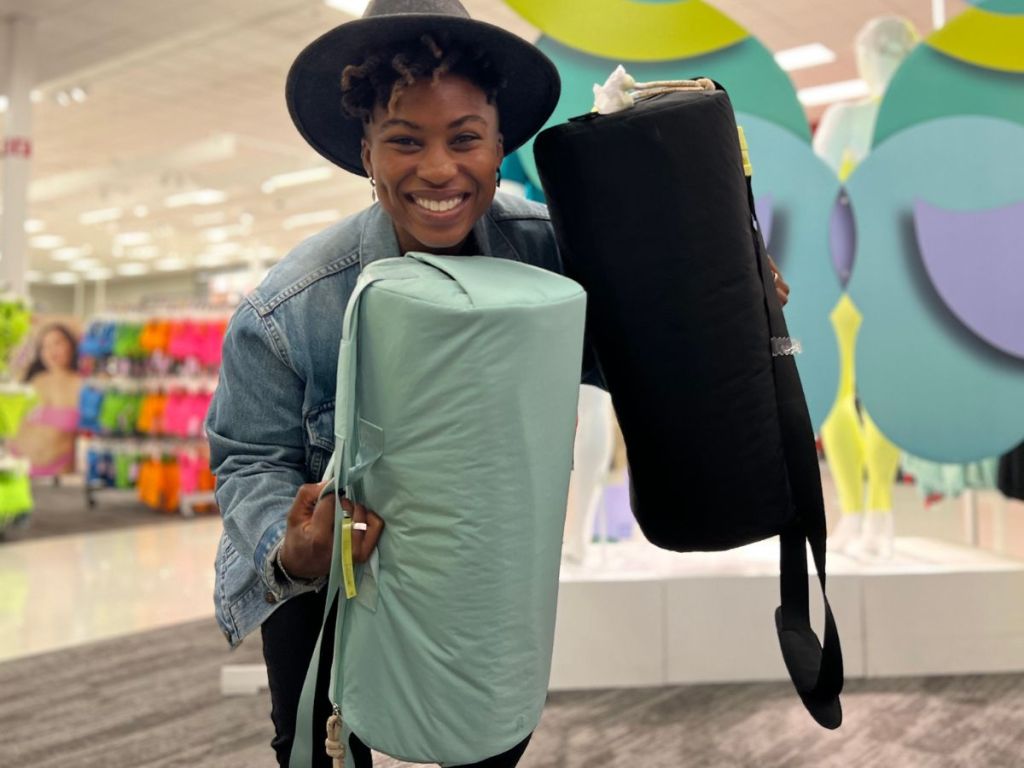 woman holding two Target All in Motion Duffel Bags