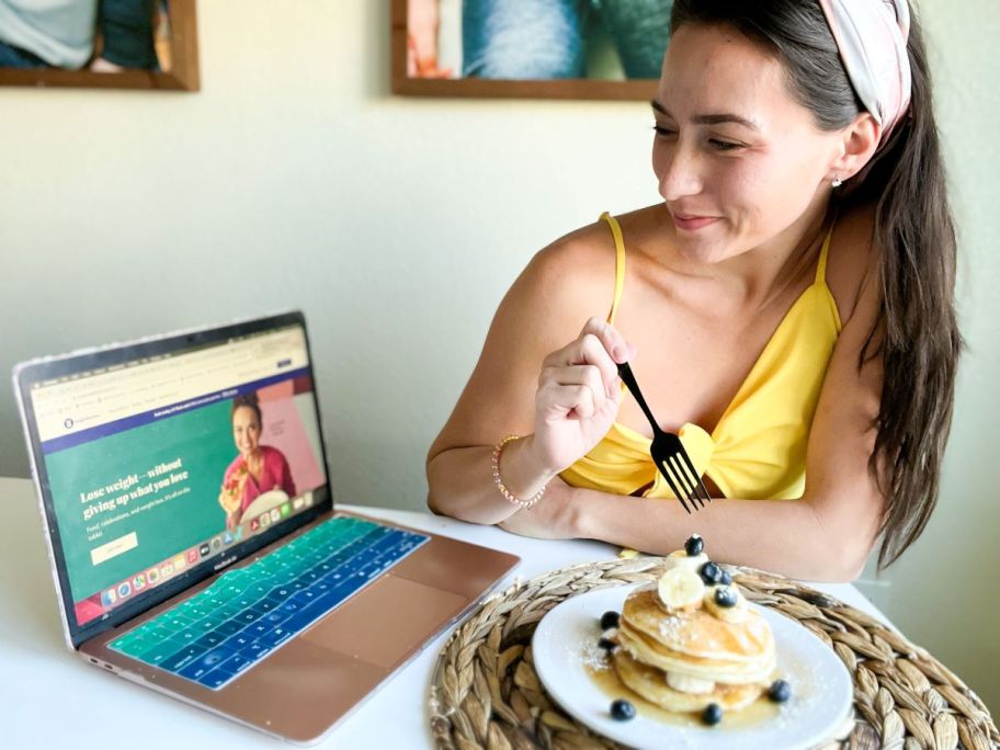 woman looking at Weight Watchers on her computer