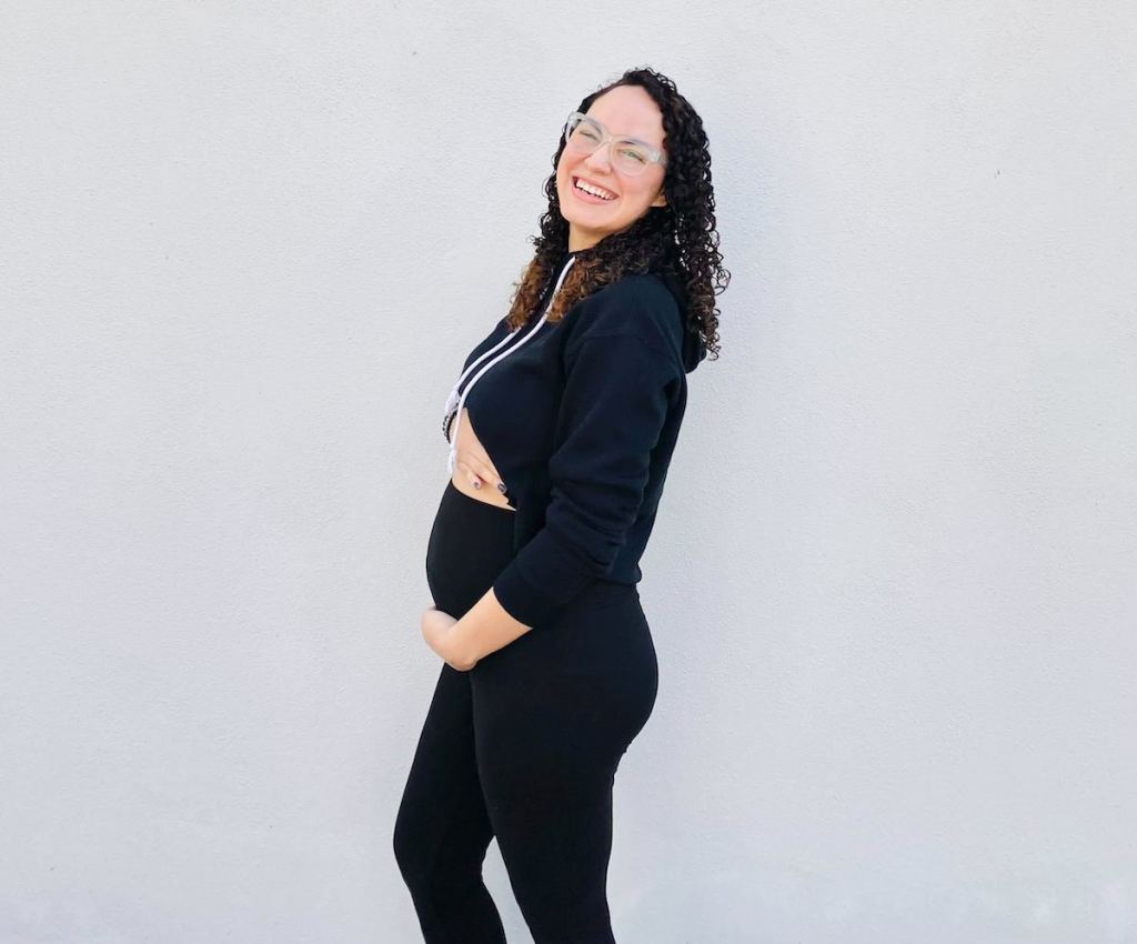 pregnant woman posing in black maternity leggings