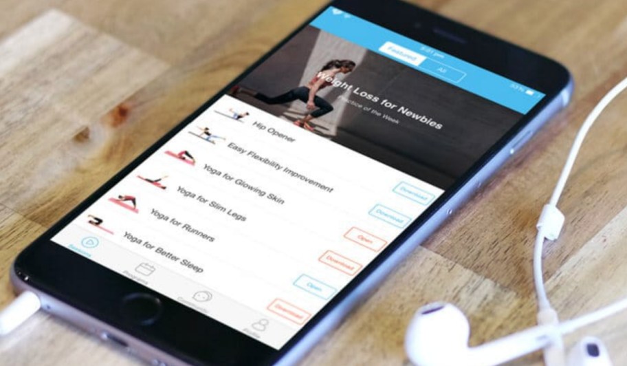 daily yoga app on phone screen with headphones
