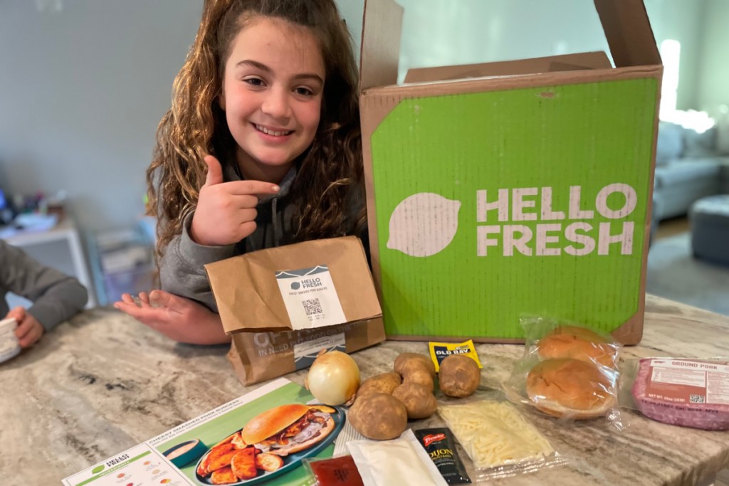 girl pointing to hello fresh box