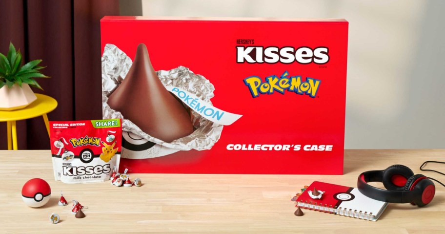 hershey's pokemon case and kisses, pokeball, notebook and headphones on a table 