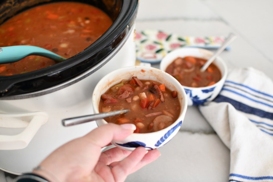 holding a bowl of 15 bean soup