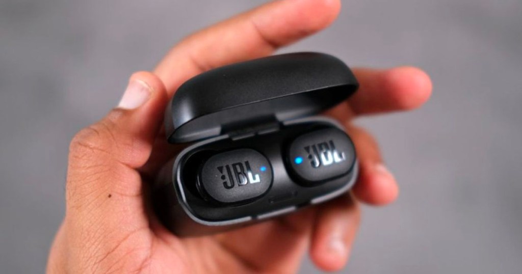 hand holding JBL headphones