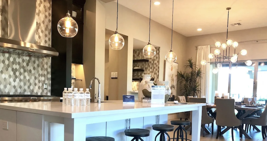 kitchen with various globe lights hanging from ceiling