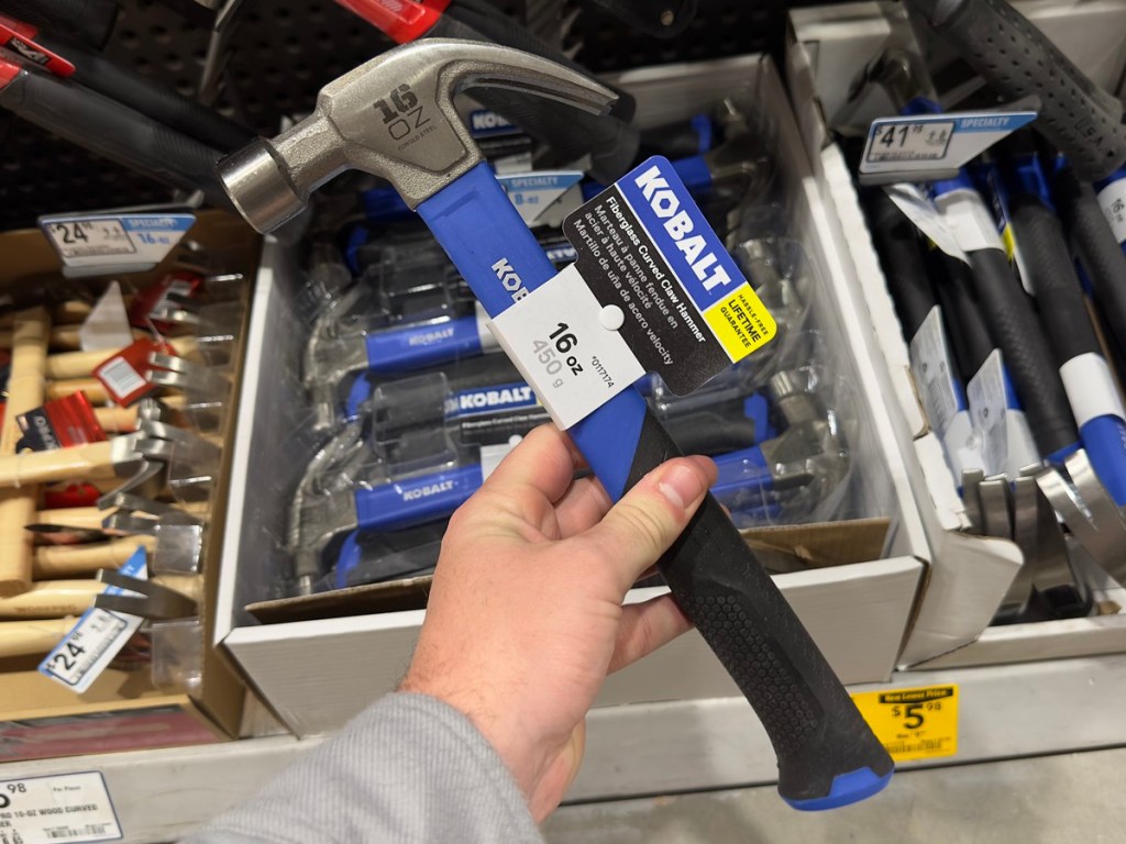 man holding a kobalt hammer at Lowe's