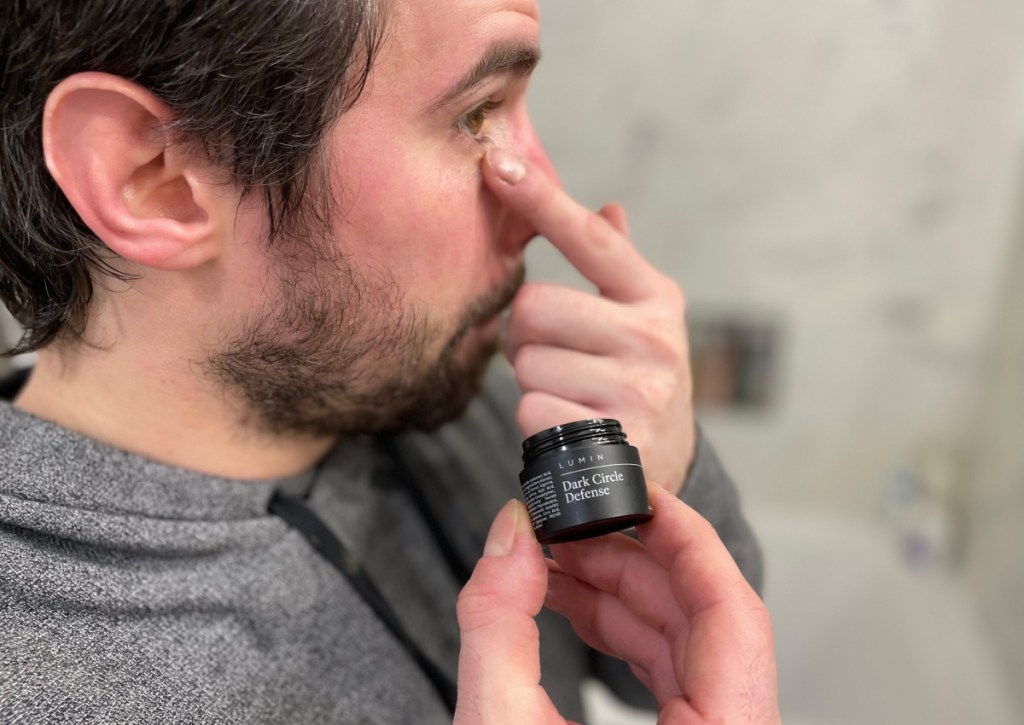 man applying eye cream