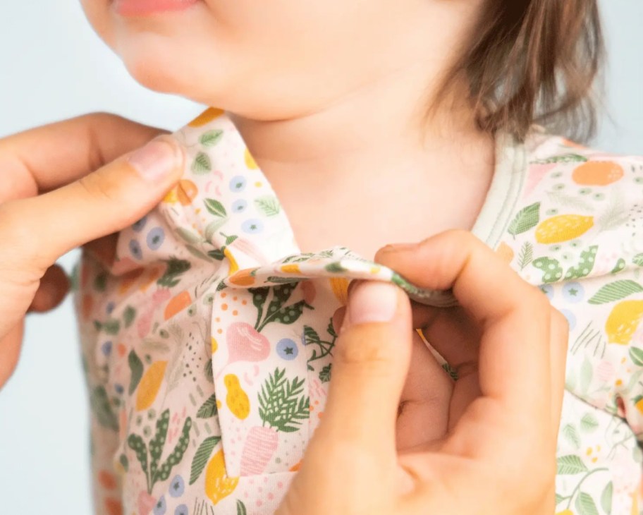 hands unsnapping magnetic baby clothes