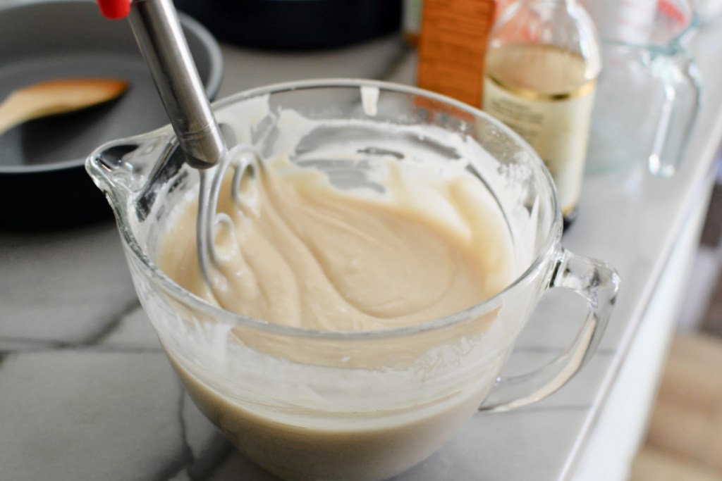 mixing vanilla cake batter in a glass batter bowl