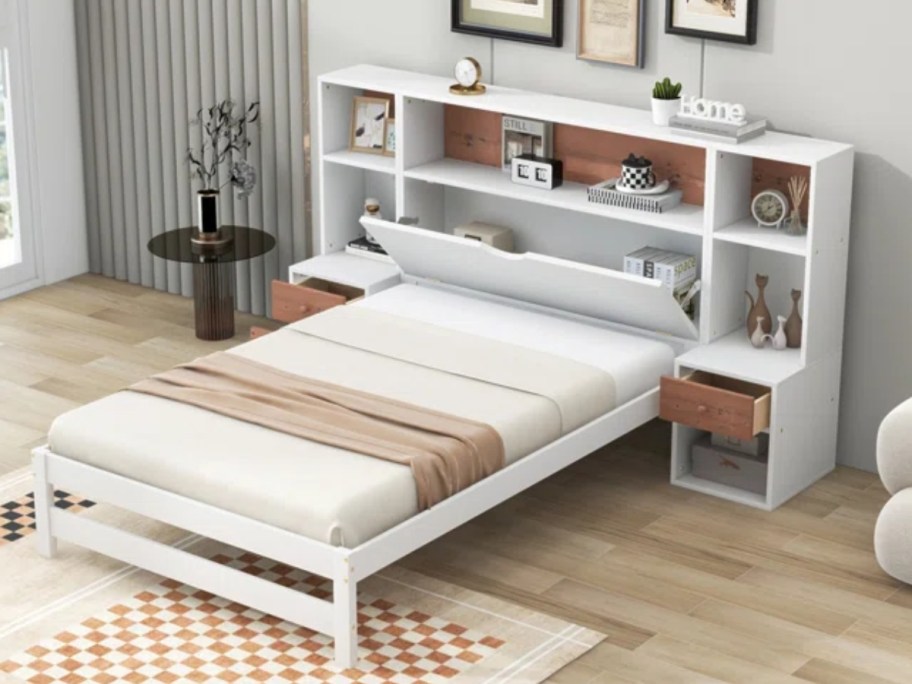 white platform bed frame with a large bookcase headboard in a room