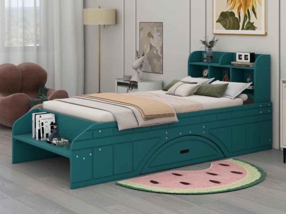 teal green kid's twin bed with storage bookcase headboard and bench in a kids bedroom