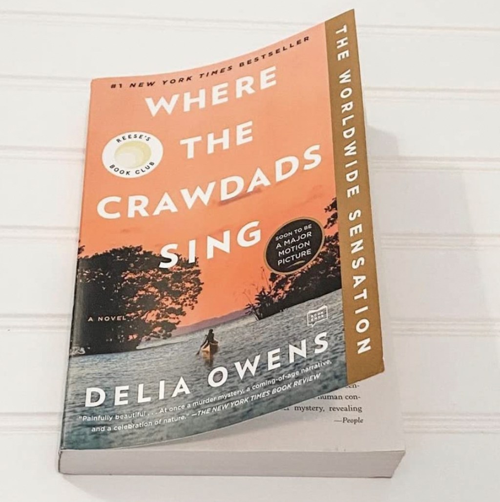 where the crawdads sing book on white table