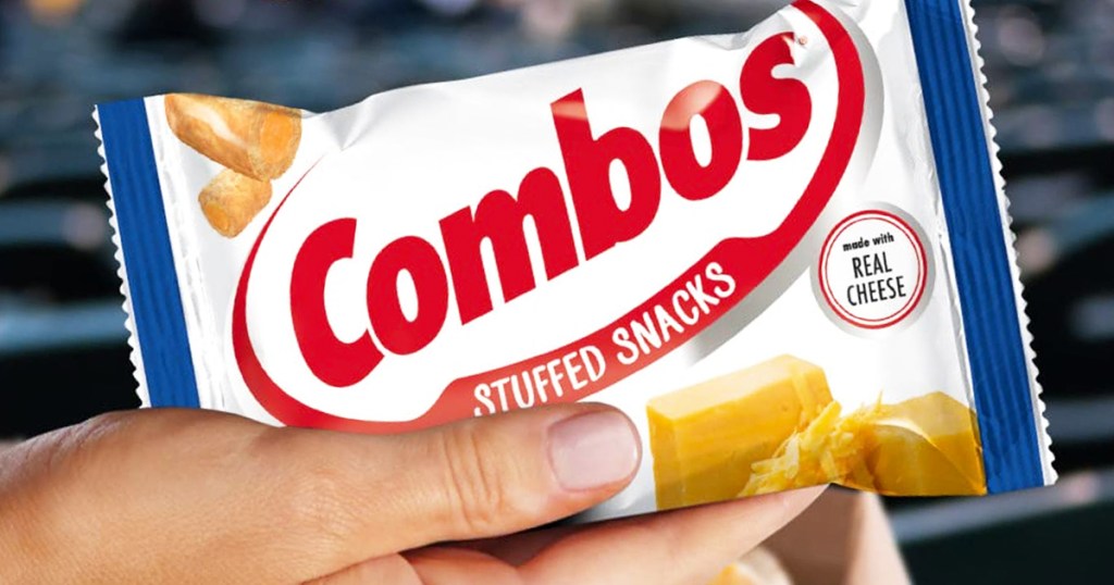 woman's hand holding snack size bag of cheddar cheese cracker snacks