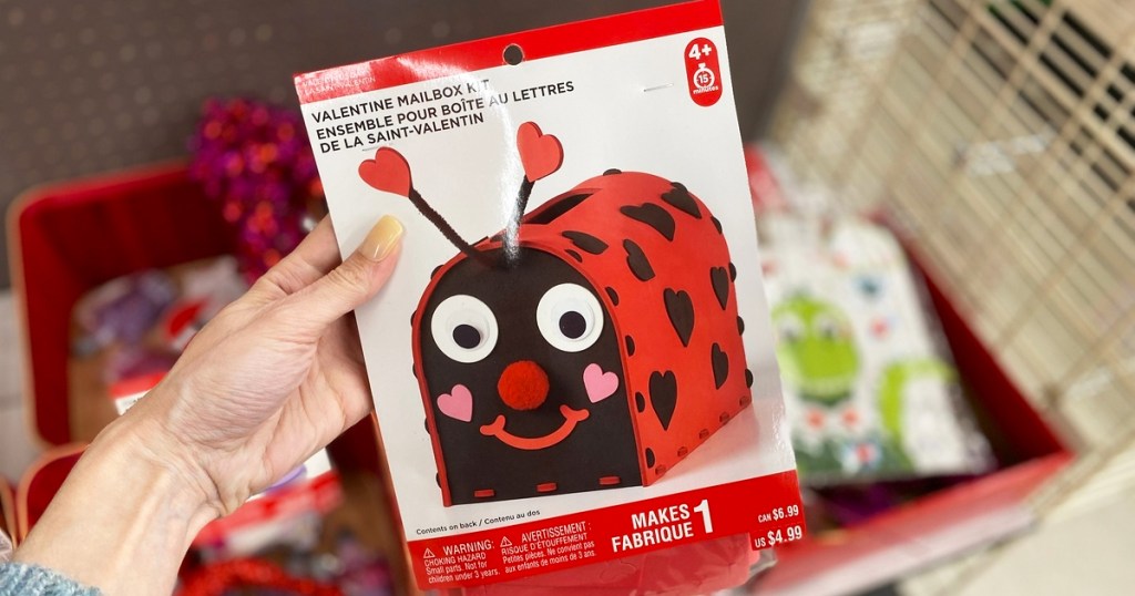 hand holding up a ladybug Valentine's Day mailbox craft kit