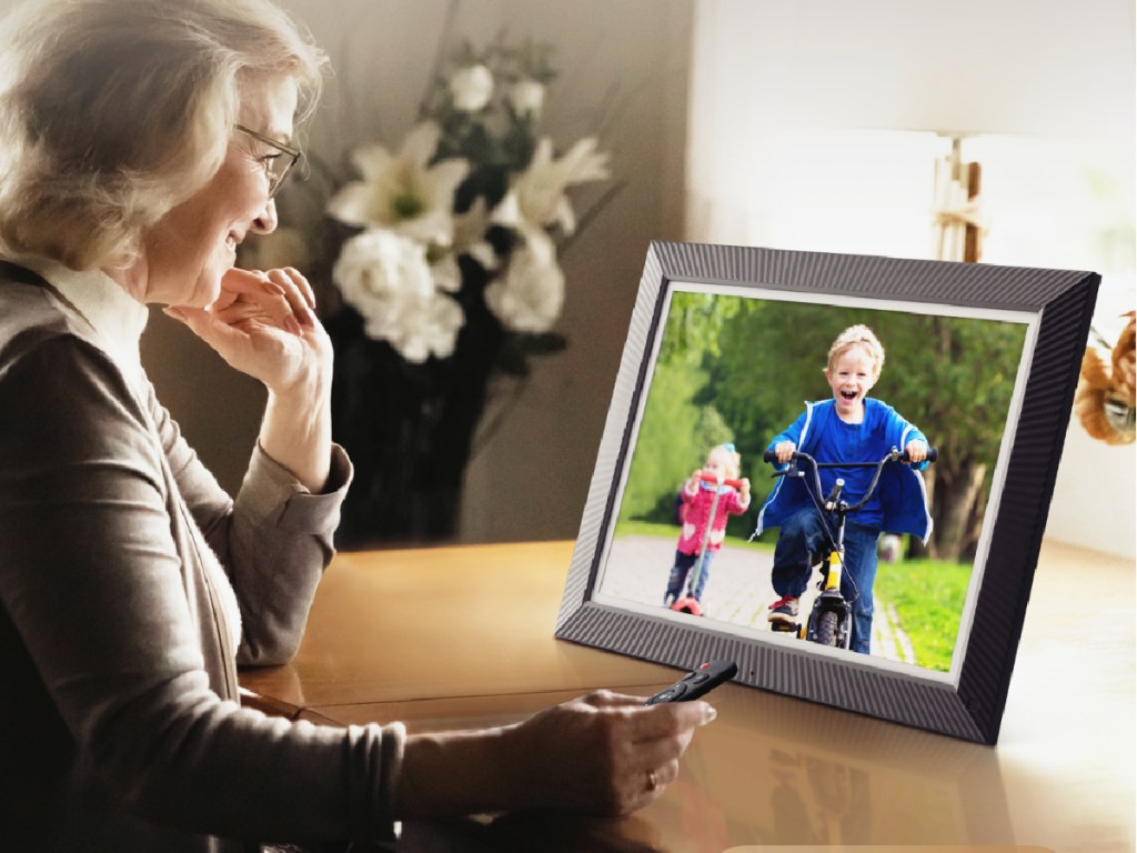 woman in front of a digital picture frame