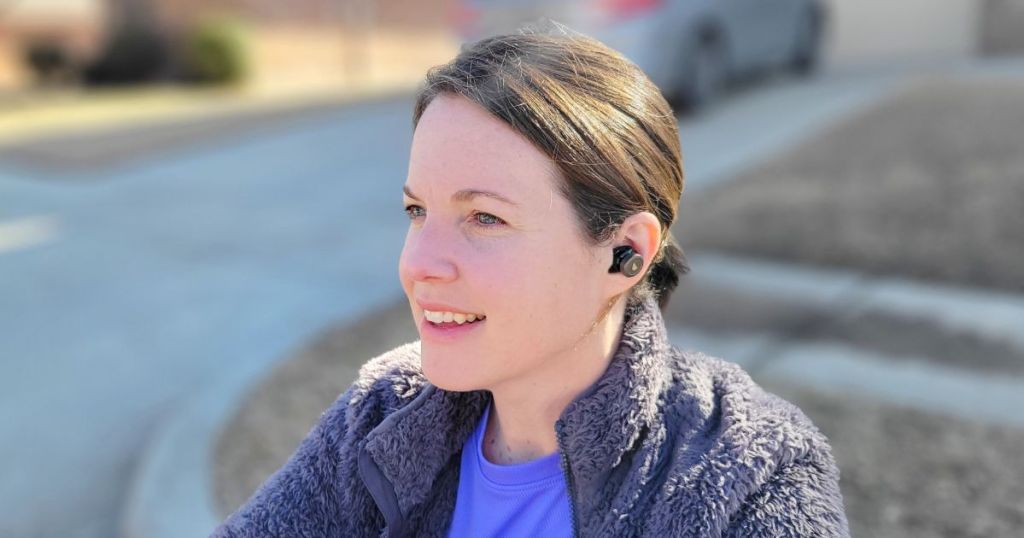 person wearing earbuds outside