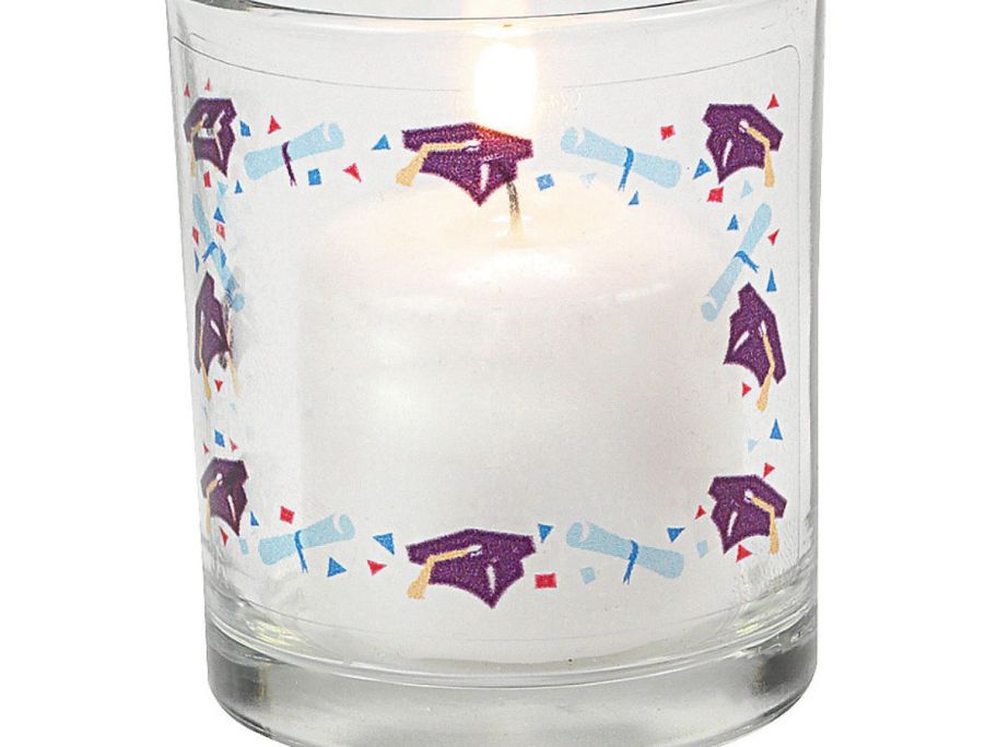 A candle with a graduation sticker on it 
