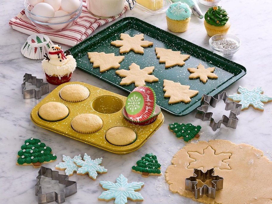 a baking sheet, muffin tin, cookie cutters and baking supplies and cookies 