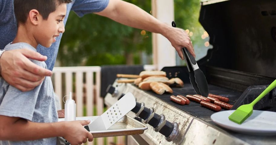 adult and child using KOYMISKU Grill Tool Accessories 15-Piece Set at the grill outside