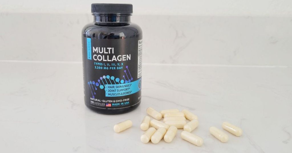 bottle of Raw Science Multi Collagen Pills on counter with pills spread out beside bottle