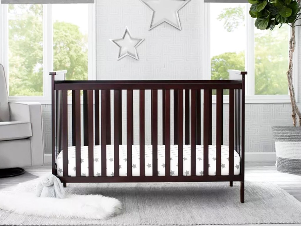 dark brown crib in a nursery