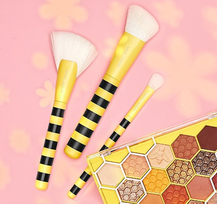 Three Tarte beauty brushes and a palette