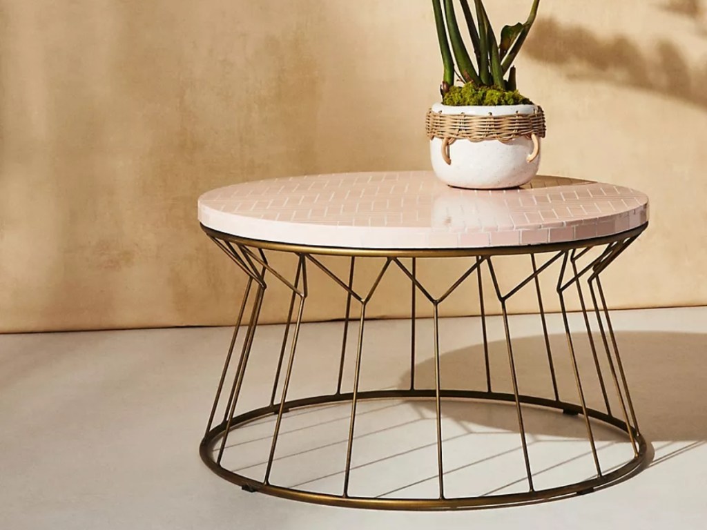 round coffee table with metal base and tile top