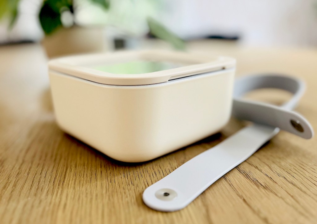 close up of white closed lid containers on table