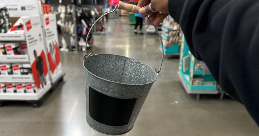 hand holding metal easter pail with chalkboard