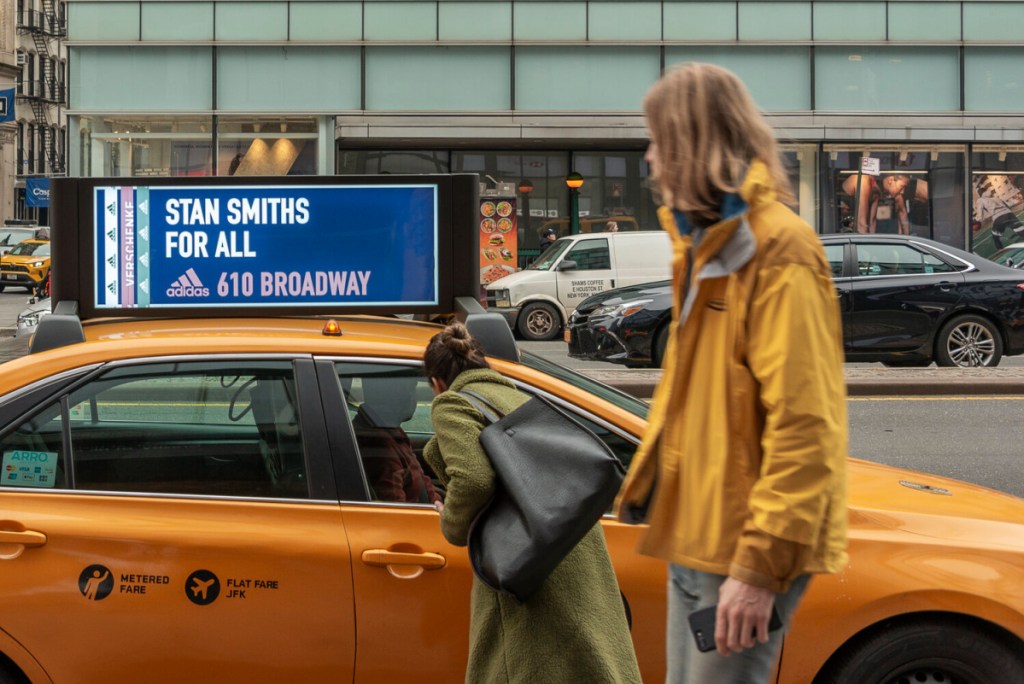 woman looking at a billboard car advertisement