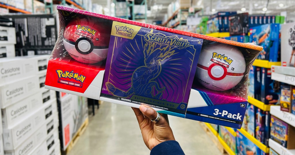 hand holding pokemon trainer box with pokeballs