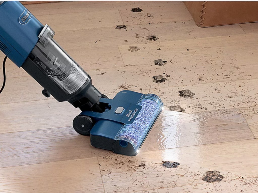 shark hydrovac xl in blue cleaning up a mess