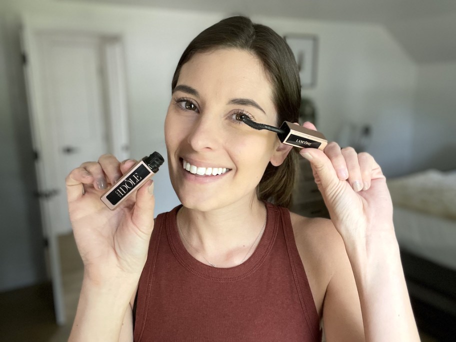 woman putting on Lancome mascara 