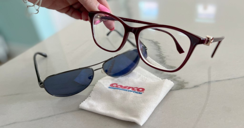 Woman holding Costco eye glasses from the Costco Vision Center