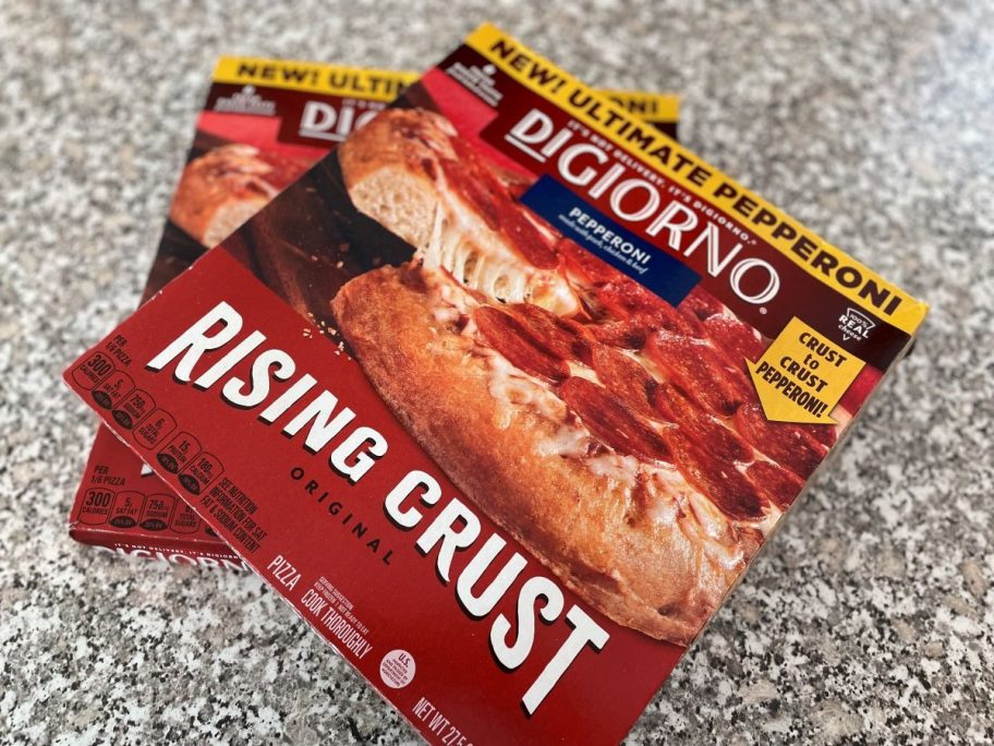 Two Digiorno pizzas sitting on a kitchen counter