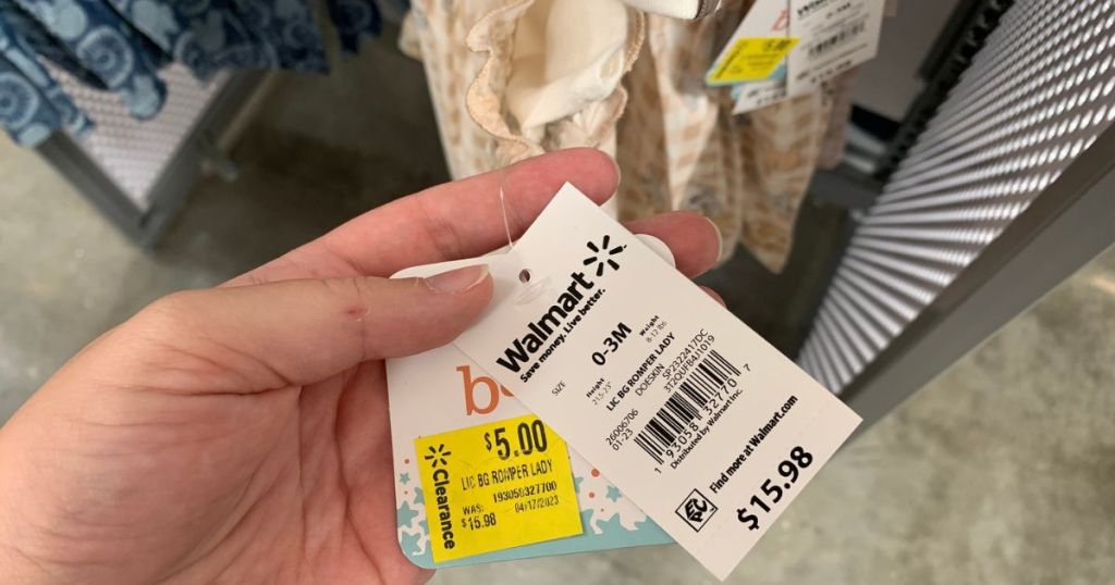 hand holding price tags for Disney baby rompers sets showing a $5 clearance sticker