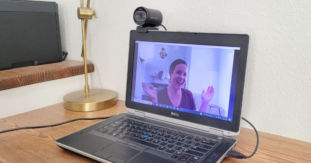 webcam attached to laptop with woman on laptop