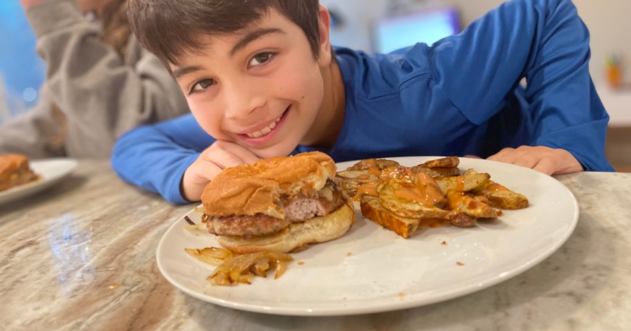 young boy near Hello Fresh burger