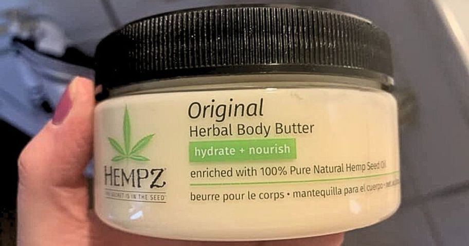 holding jar of Hempz Body Butter