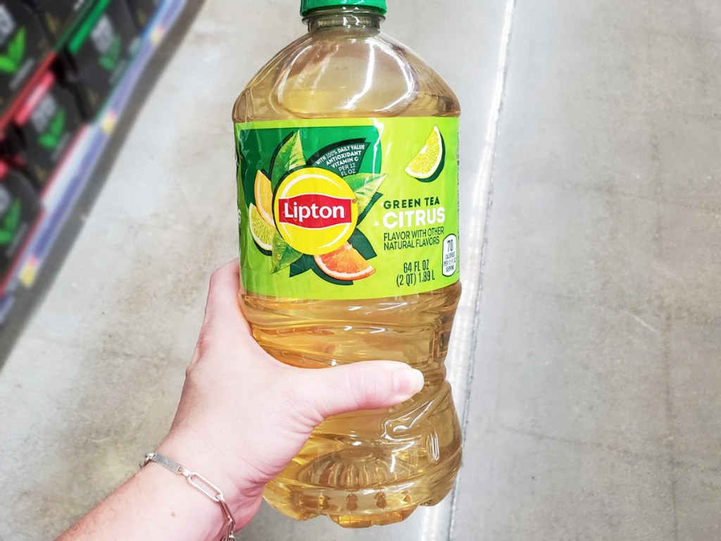hand holding a large bottle of lipton tea