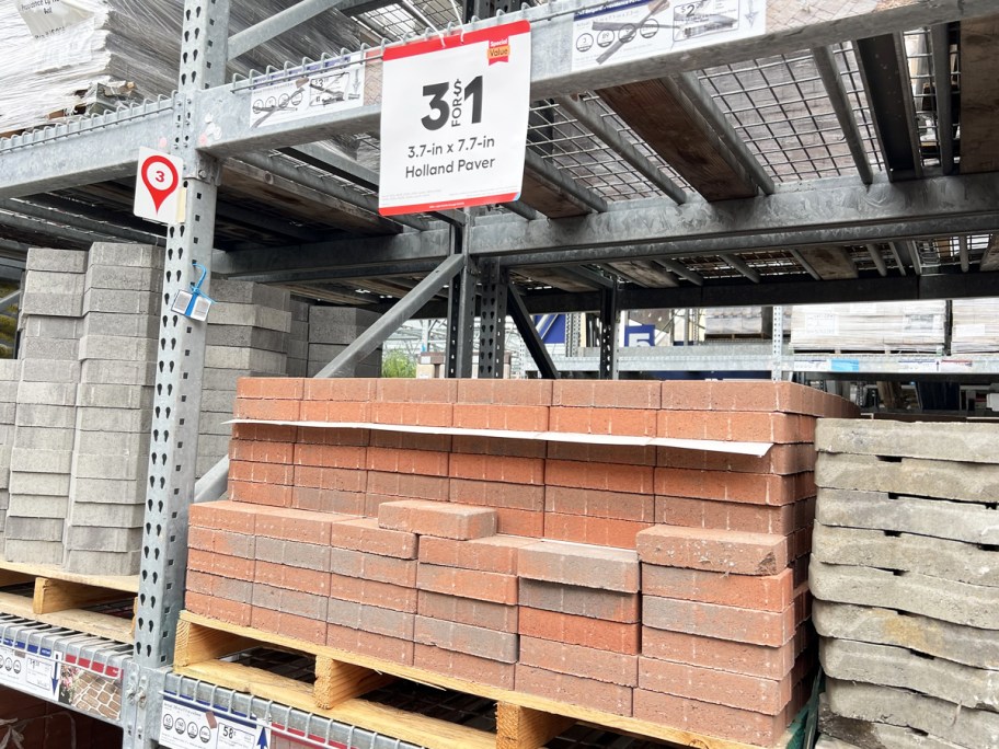 stack of red paver bricks on display at lowe's