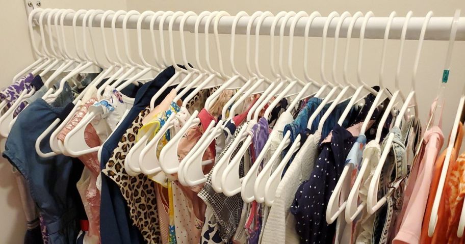 Closet with children's clothes hanging on plastic hangers