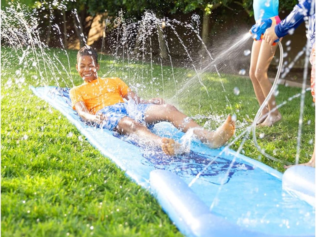 kid sliding down a nerf super soaker slide