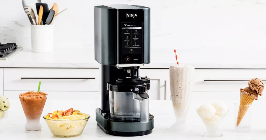 black ninja creami machine on counter with various ice cream treats