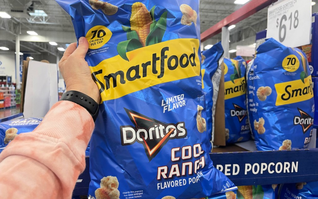 Woman holding a bag of Smartfood Doritos Cool Ranch Popcorn she found at Sam's Club