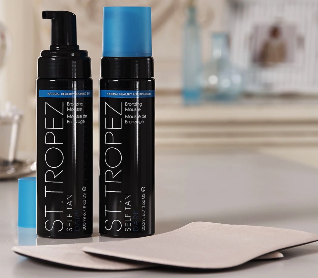 two bottles of St. Tropez Dark Self Tan Mousse and two applicator mitts