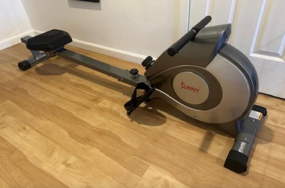 sunny life rowing machine on light maple wood floor